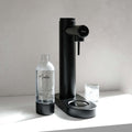 Front view of a black soda maker or sparkling water maker